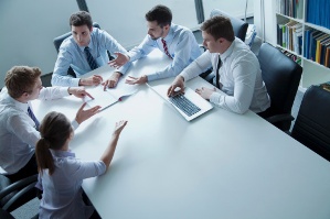 Five business people having a meeting